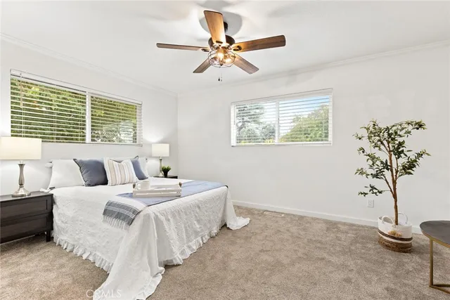 a bedroom with bed and a potted plant