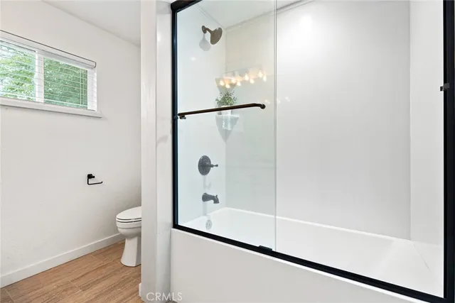 a bathroom with a glass shower door