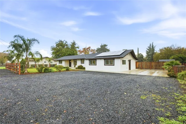a view of a house with a yard and sitting area