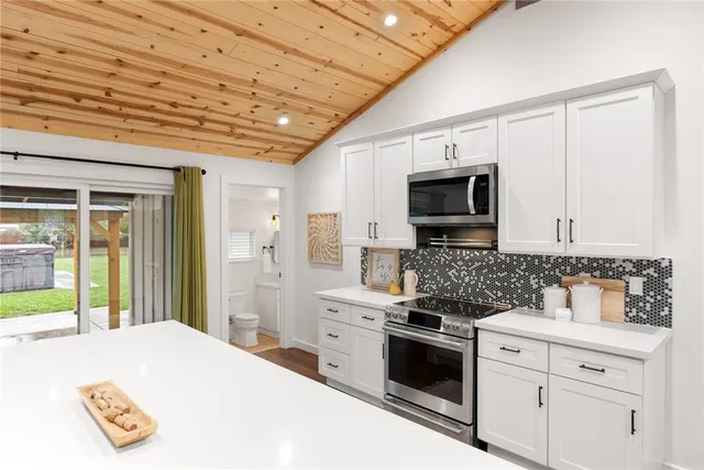 a kitchen with a stove a sink and a refrigerator