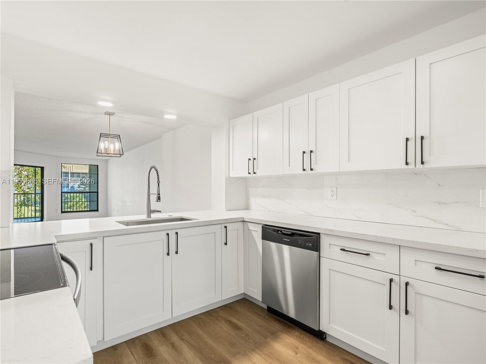 7547 Fairfax Drive, Unit 210 Tamarac, FL 33321 - Photo 11 of 38 a kitchen with white cabinets white appliances sink and dishwasher
