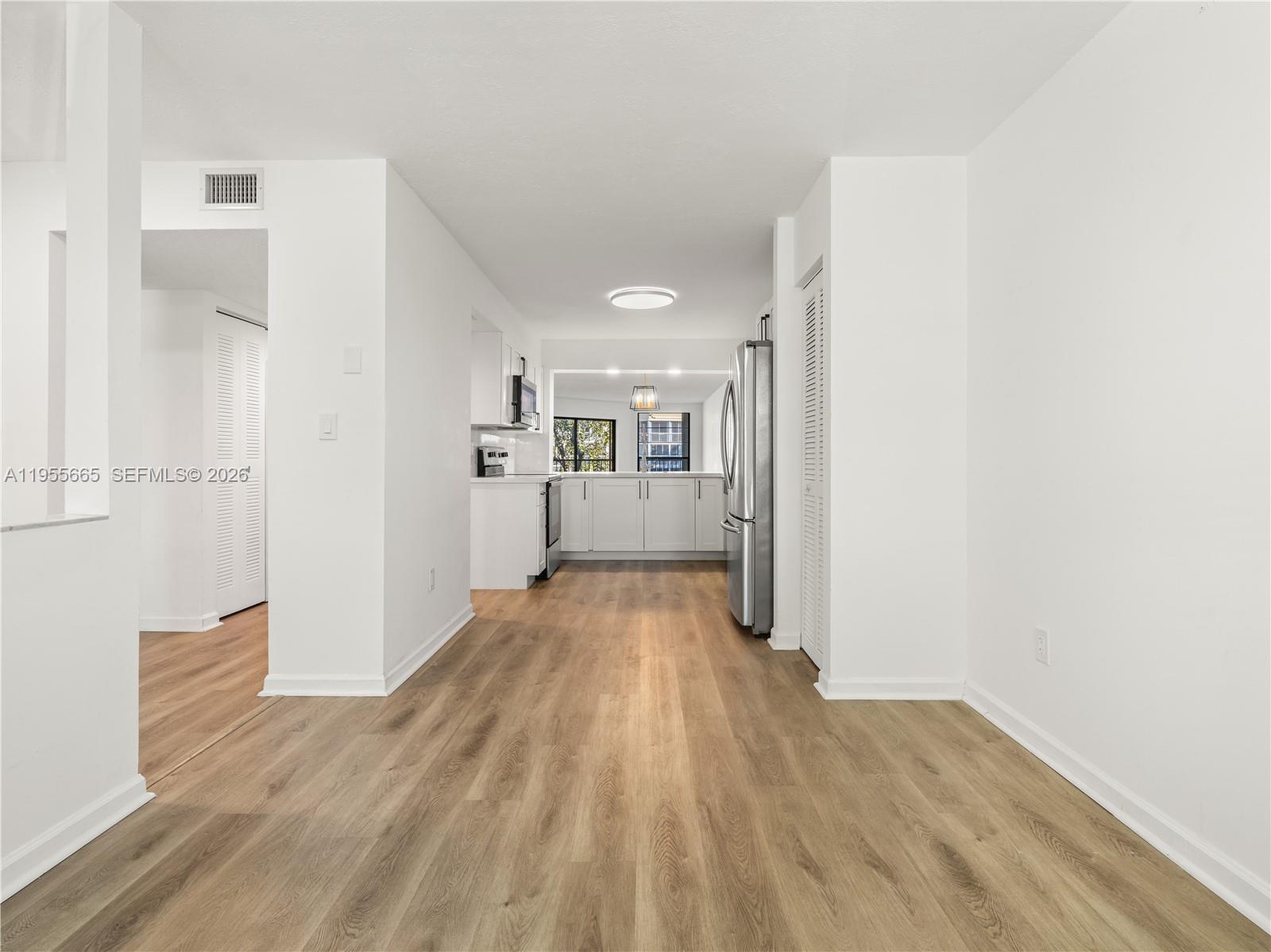 7547 Fairfax Drive, Unit 210 Tamarac, FL 33321 - Photo 13 of 38 a view of a kitchen with a refrigerator and a sink
