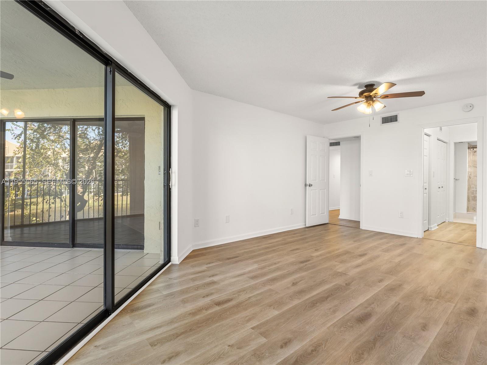 7547 Fairfax Drive, Unit 210 Tamarac, FL 33321 - Photo 16 of 38 a view of empty room with wooden floor and fan