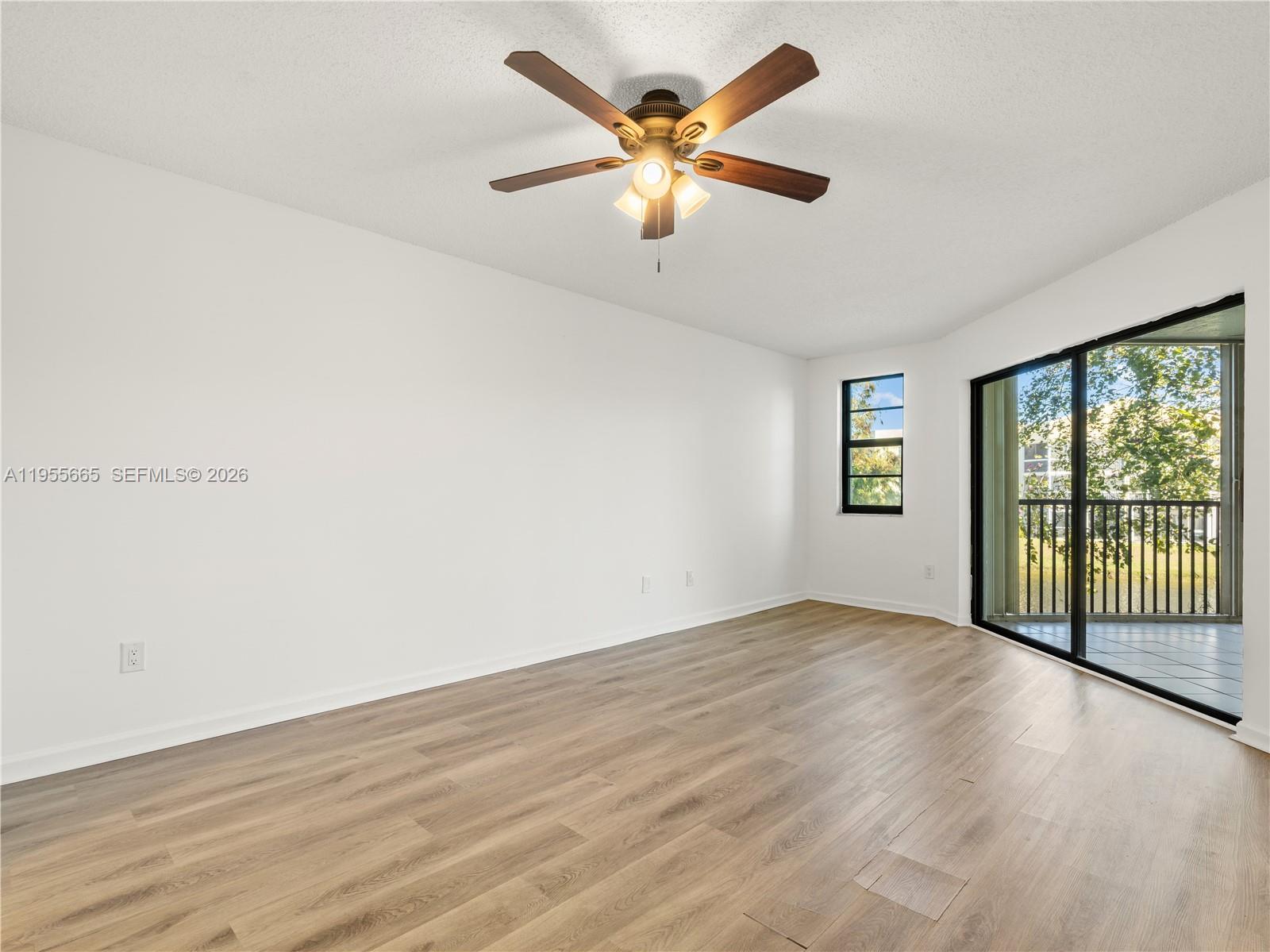7547 Fairfax Drive, Unit 210 Tamarac, FL 33321 - Photo 17 of 38 wooden floor in an empty room with a window