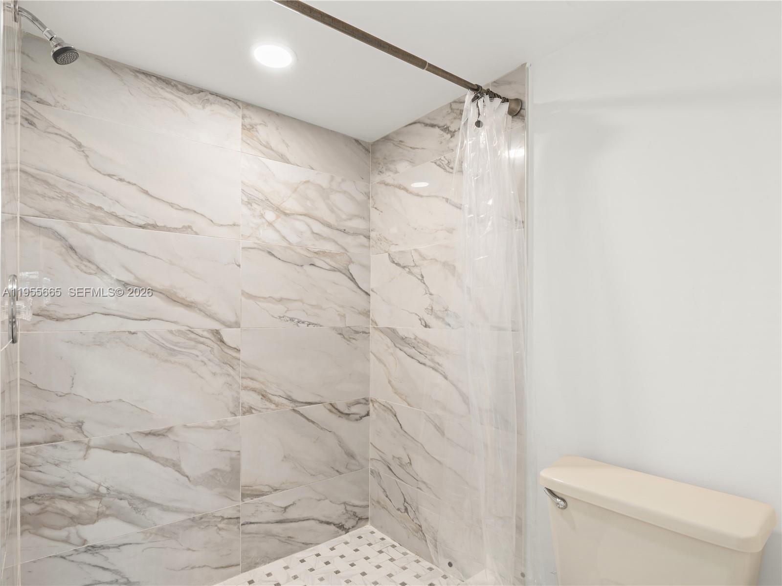 7547 Fairfax Drive, Unit 210 Tamarac, FL 33321 - Photo 18 of 38 a bathroom with a shower and a toilet