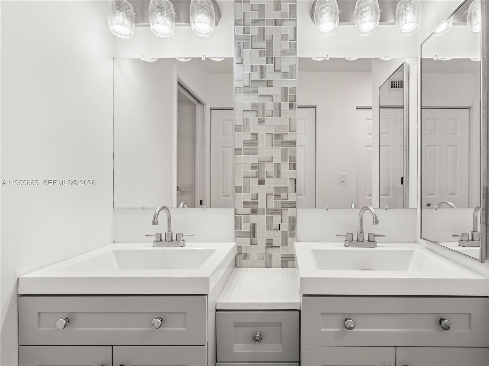 7547 Fairfax Drive, Unit 210 Tamarac, FL 33321 - Photo 19 of 38 a bathroom with a sink and a mirror