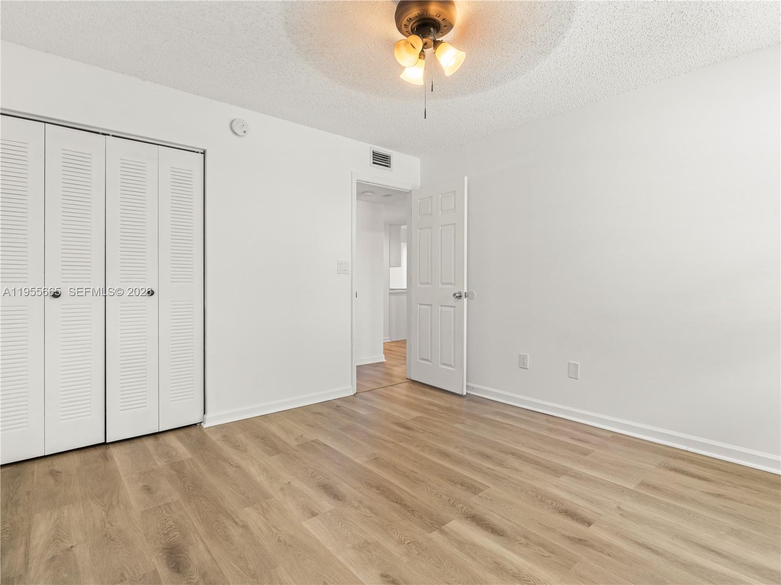 7547 Fairfax Drive, Unit 210 Tamarac, FL 33321 - Photo 22 of 38 wooden floor in an empty room