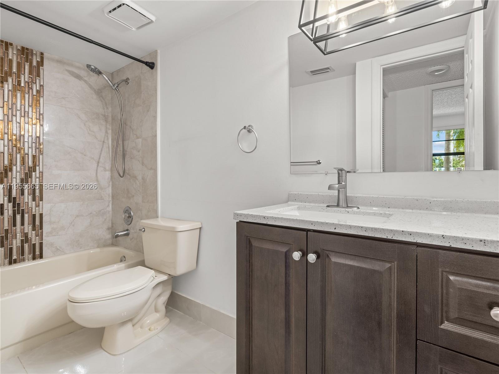 7547 Fairfax Drive, Unit 210 Tamarac, FL 33321 - Photo 23 of 38 a bathroom with a granite countertop sink toilet and shower