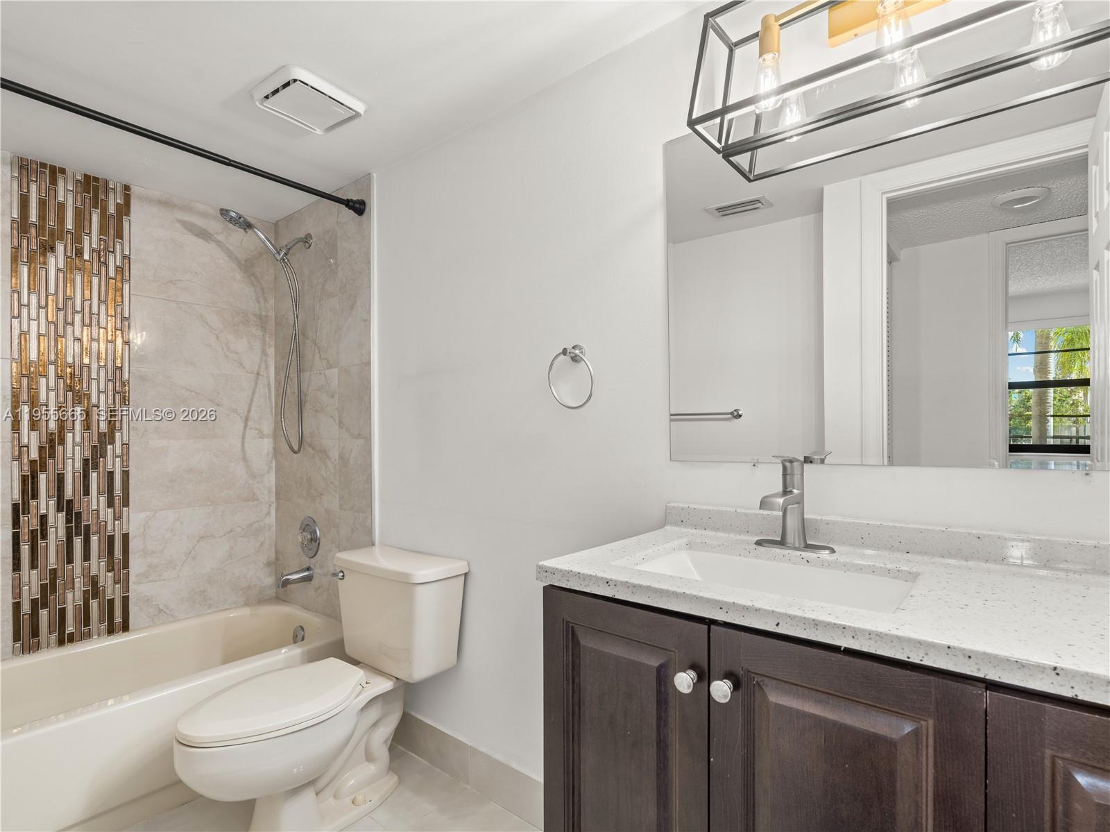 7547 Fairfax Drive, Unit 210 Tamarac, FL 33321 - Photo 27 of 38 a bathroom with a granite countertop sink toilet and shower