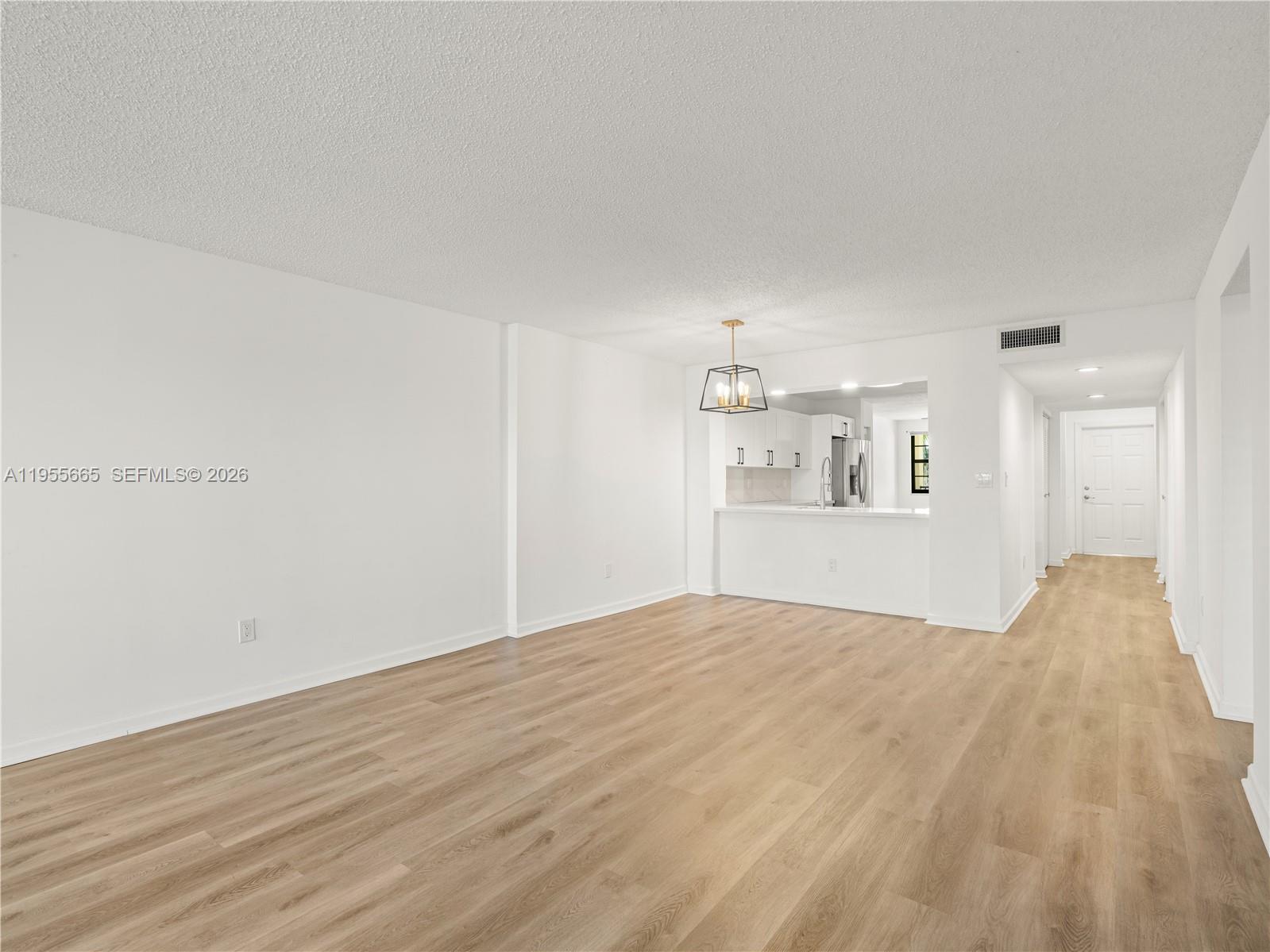 7547 Fairfax Drive, Unit 210 Tamarac, FL 33321 - Photo 6 of 38 a view of empty room with wooden floor