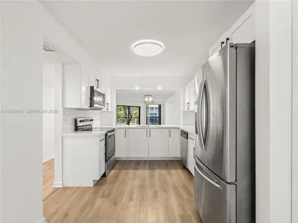 a kitchen with a refrigerator and a sink