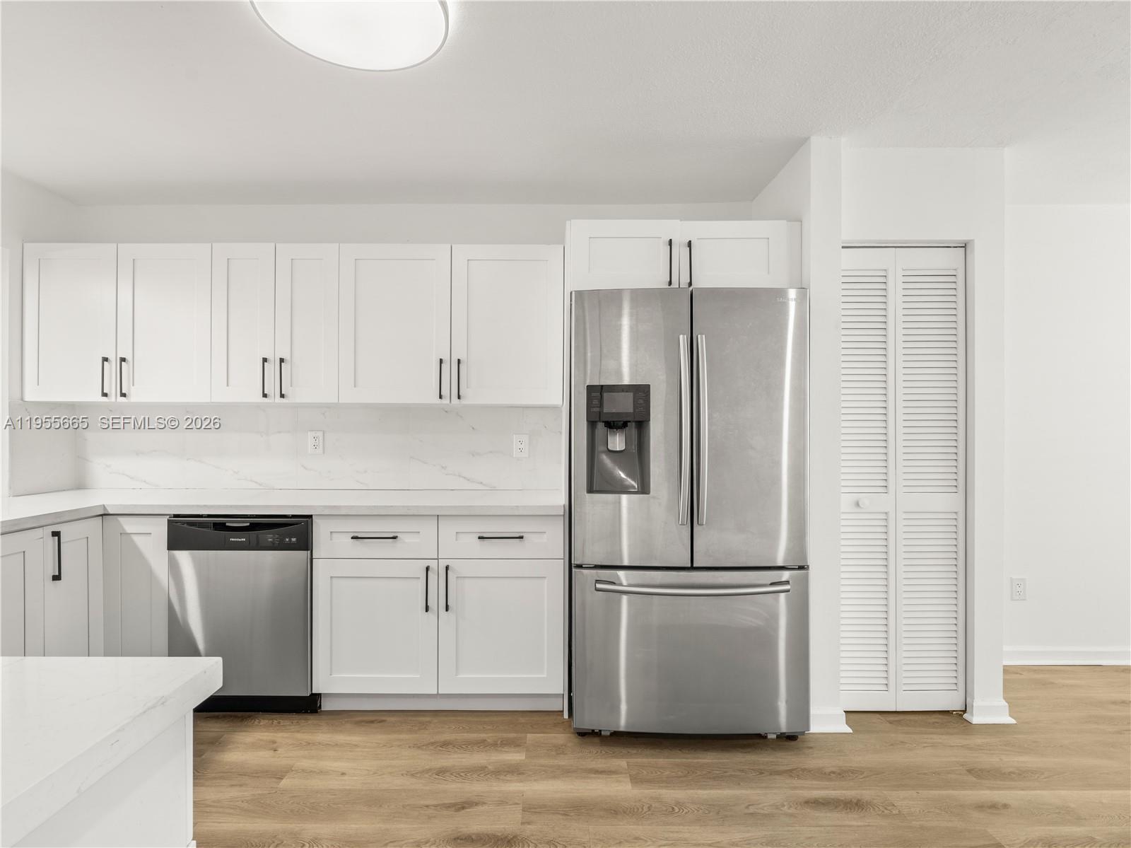 7547 Fairfax Drive, Unit 210 Tamarac, FL 33321 - Photo 9 of 38 a kitchen with cabinets and stainless steel appliances