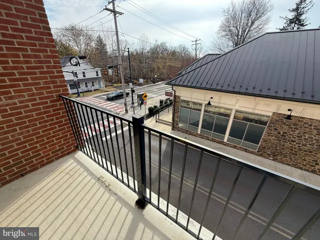 a view of a balcony with wooden floor and fence