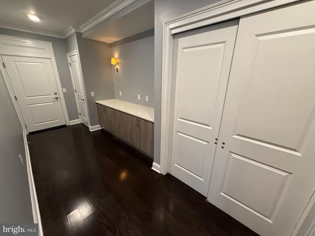 a view of hallway with stairs and wooden floor