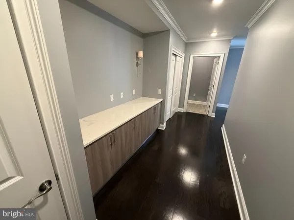 a view of hallway with stairs and wooden floor