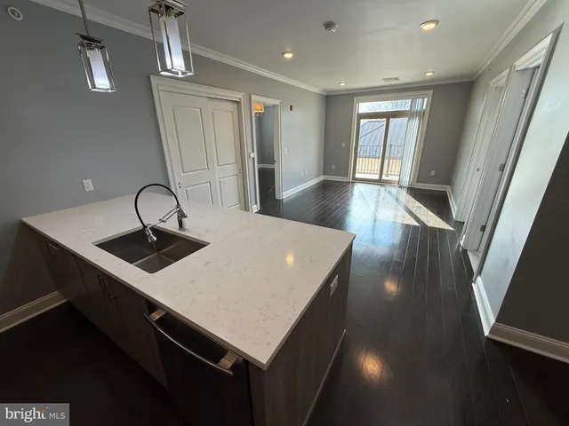 a kitchen with sink cabinets and wooden floor