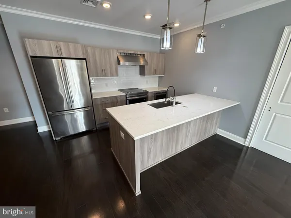 a kitchen with a refrigerator a sink and dishwasher a refrigerator with wooden floor