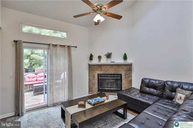 a living room with stainless steel appliances kitchen island granite countertop furniture and a view of kitchen