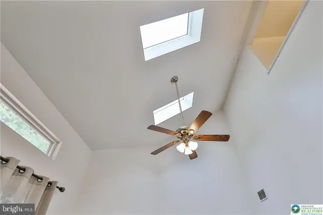 a living room with lots of furniture and a refrigerator