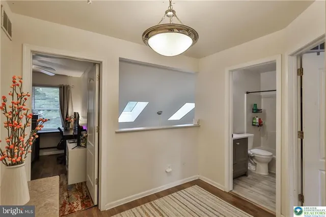 a bedroom with a bed and a television