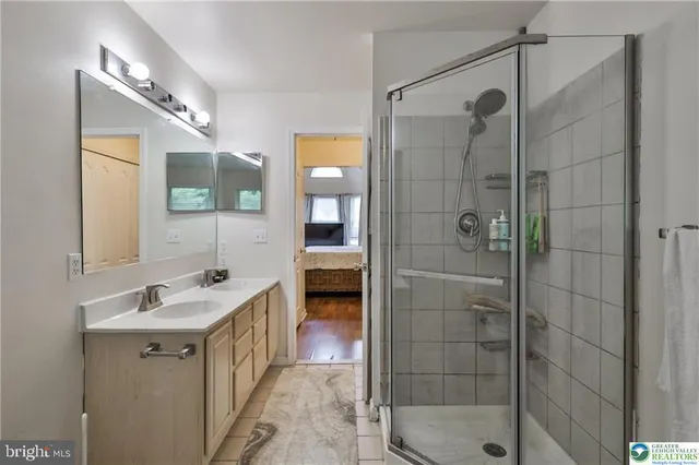 a bathroom with a sink mirror vanity and toilet