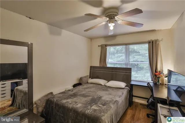 a bedroom with a large bed and a dresser