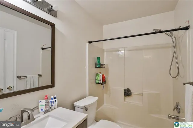 a living room with a rug and a couch