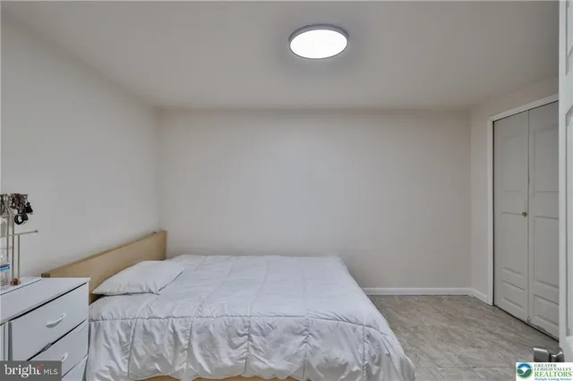 a bedroom with a bed and a night lamp