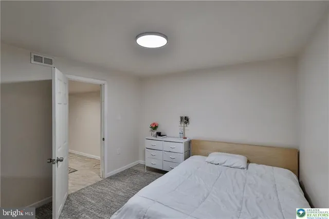 a bedroom with a bed and cabinets