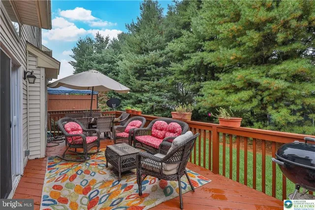 a view of a house with a yard and deck