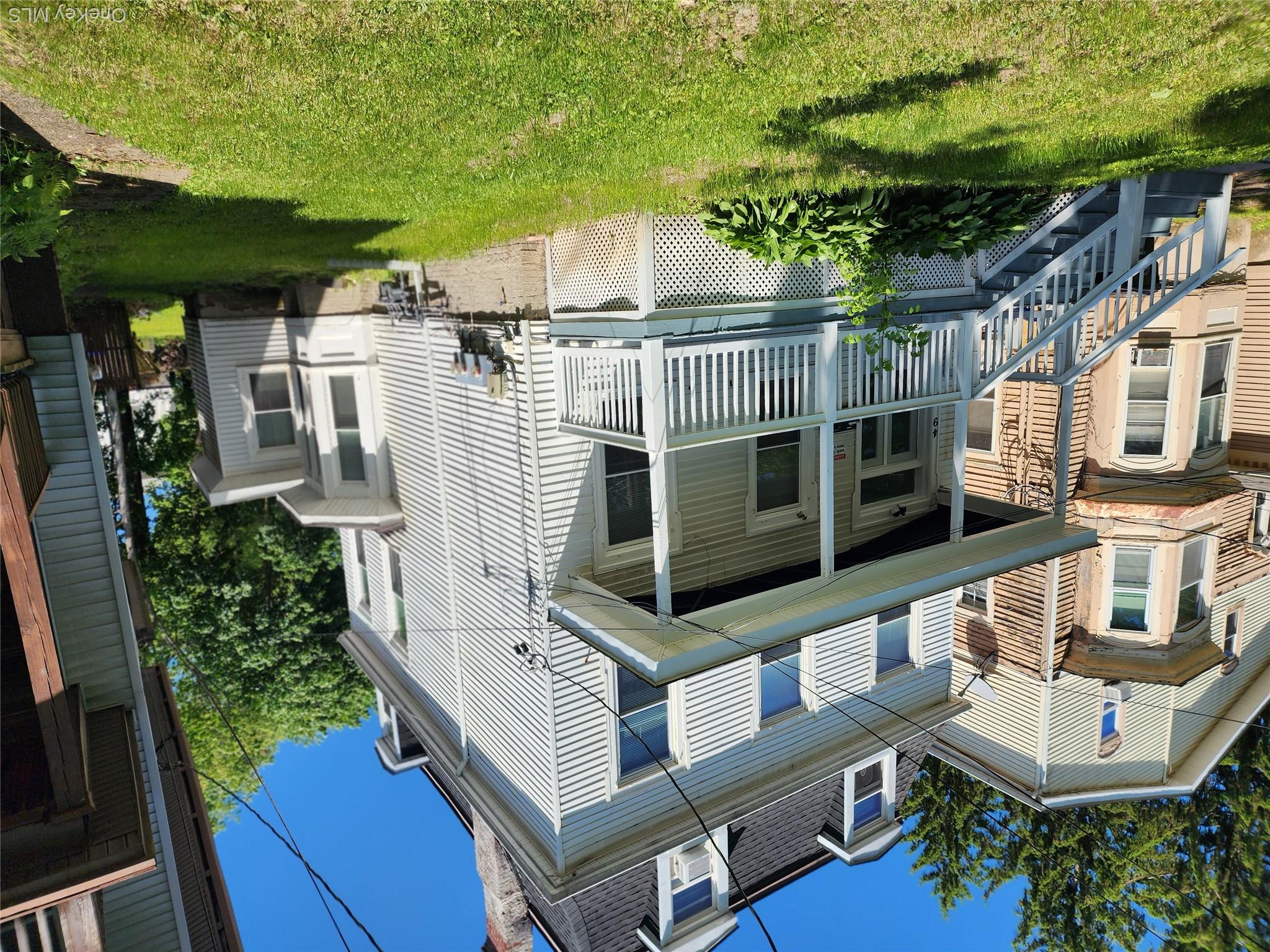 49 Carroll Street, Unit 1 Poughkeepsie, NY 12601 - Photo 1 of 15 a front view of a house with a yard
