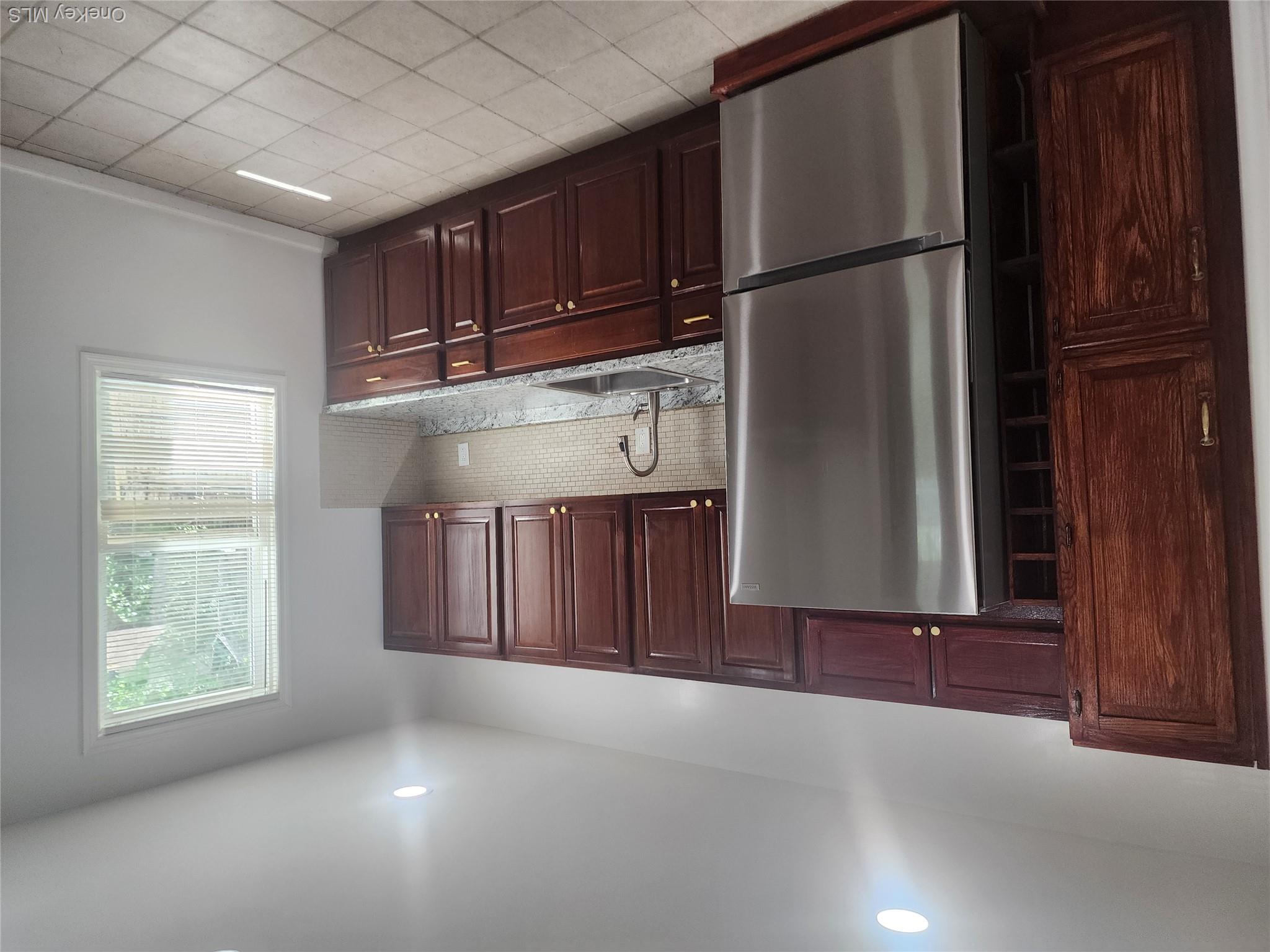49 Carroll Street, Unit 1 Poughkeepsie, NY 12601 - Photo 12 of 15 a kitchen with stainless steel appliances granite countertop a refrigerator sink and cabinets