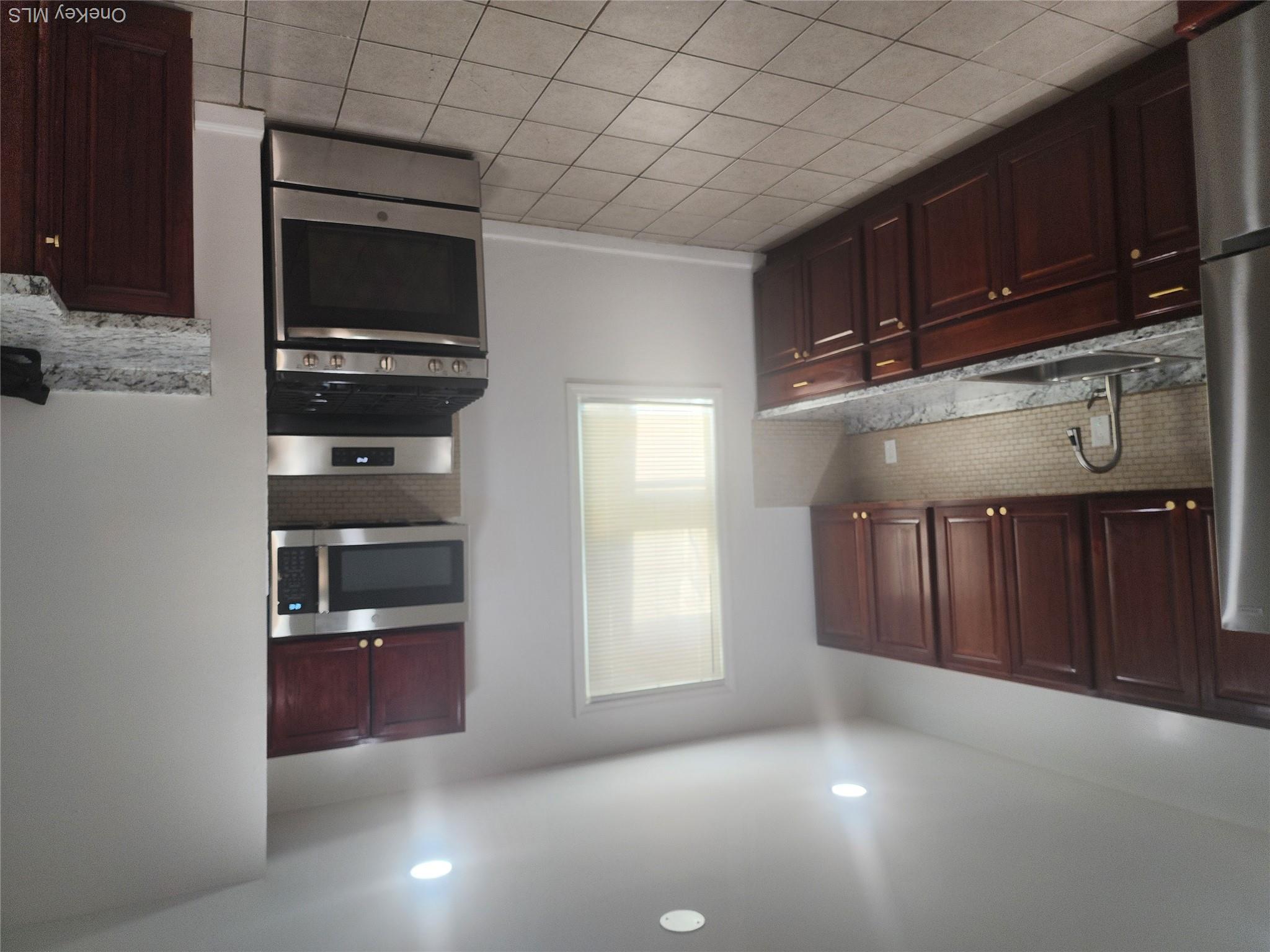 49 Carroll Street, Unit 1 Poughkeepsie, NY 12601 - Photo 14 of 15 a kitchen with stainless steel appliances granite countertop a stove sink and cabinets