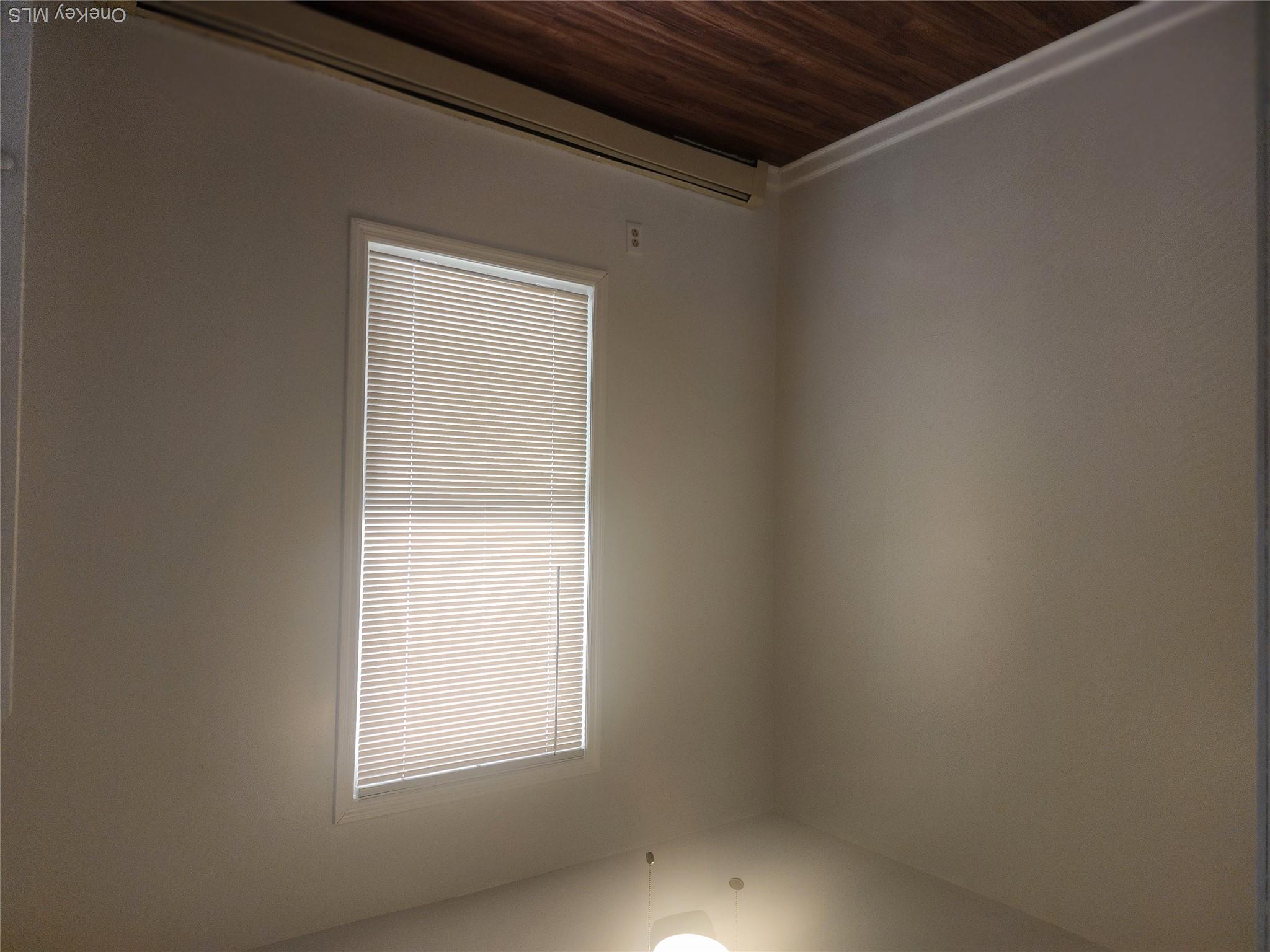 49 Carroll Street, Unit 1 Poughkeepsie, NY 12601 - Photo 15 of 15 an empty room with wooden floor and windows