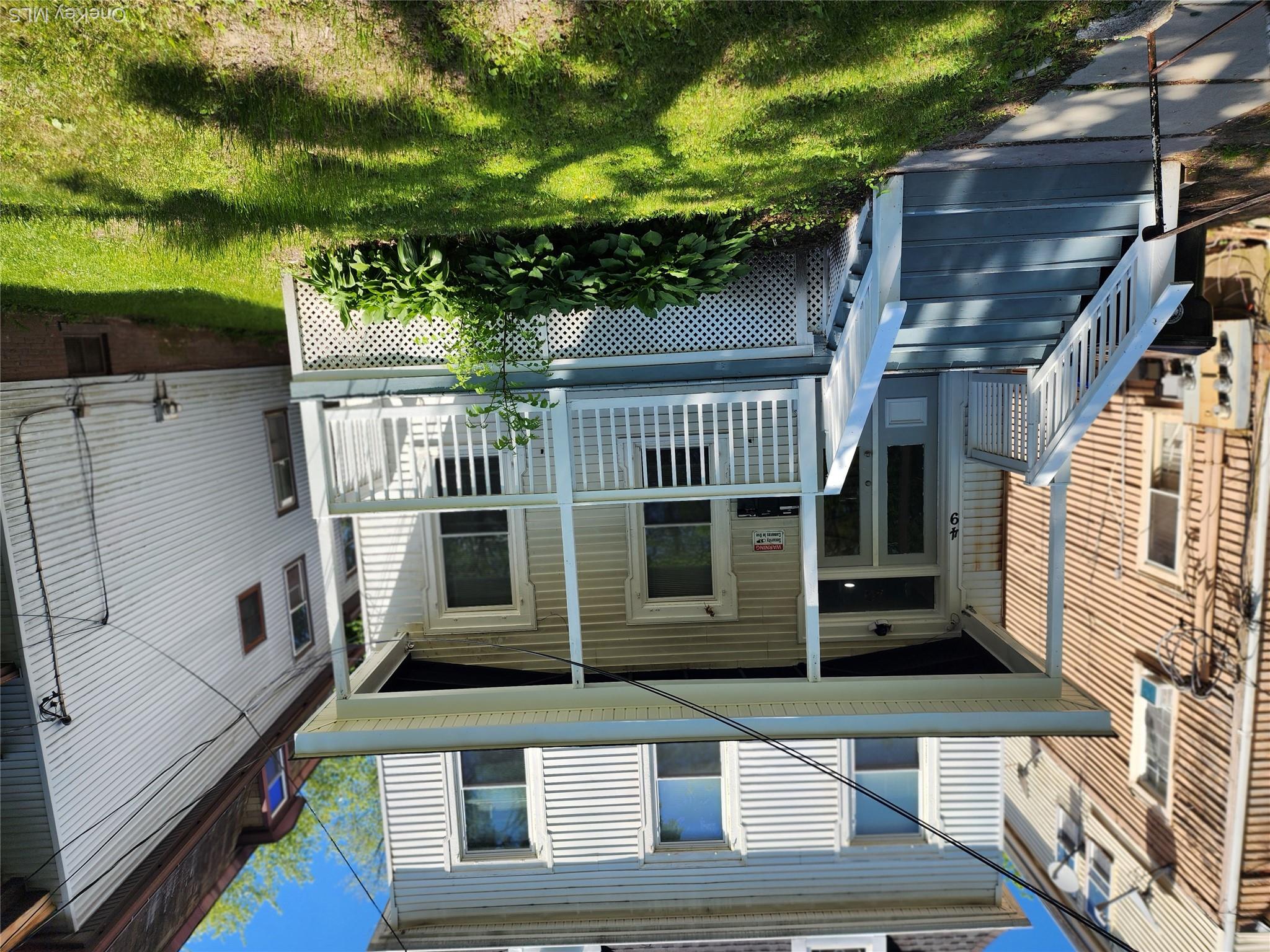 49 Carroll Street, Unit 1 Poughkeepsie, NY 12601 - Photo 2 of 15 a front view of a house with a yard