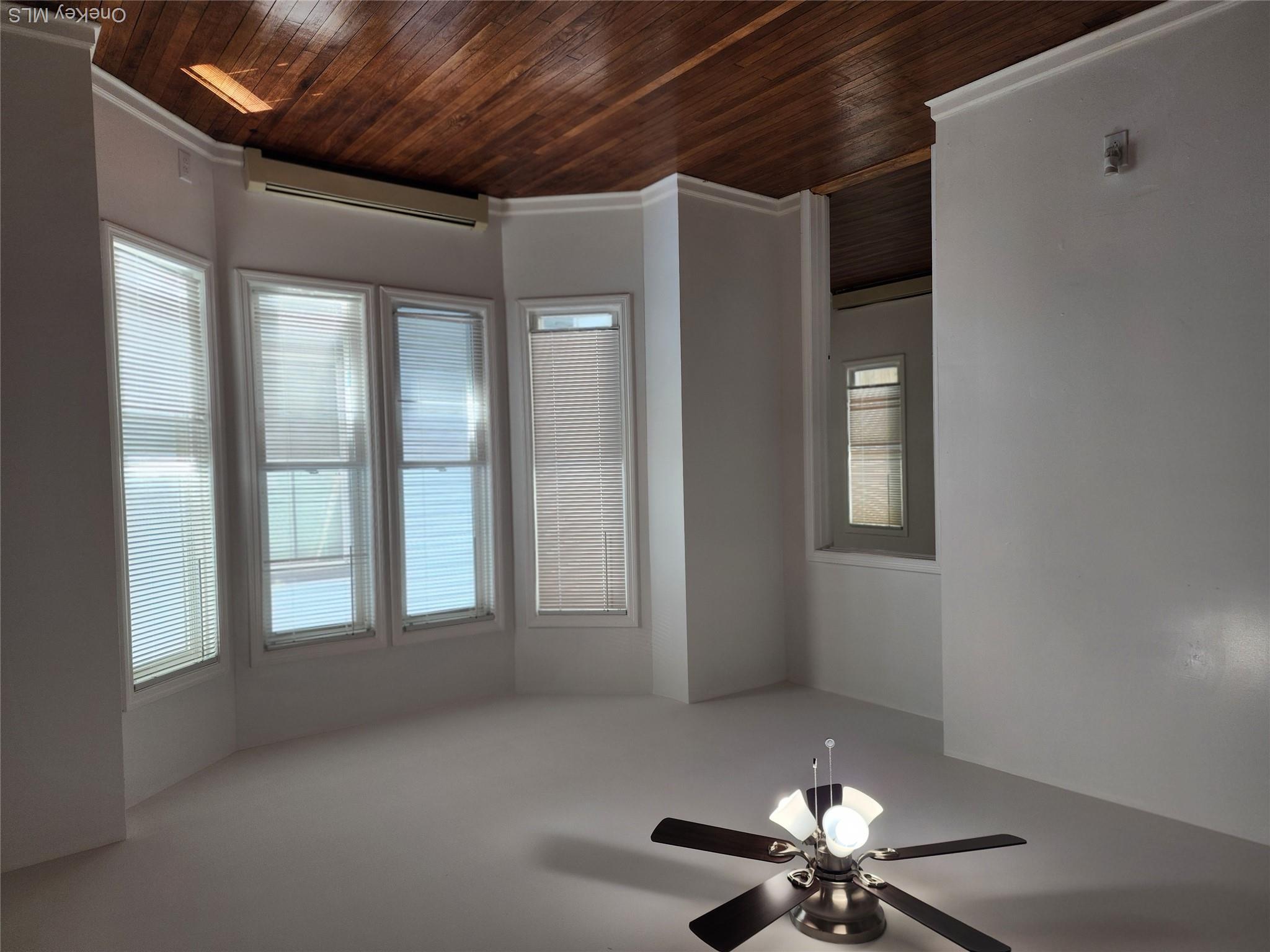 49 Carroll Street, Unit 1 Poughkeepsie, NY 12601 - Photo 6 of 15 wooden floor in an empty room with a window