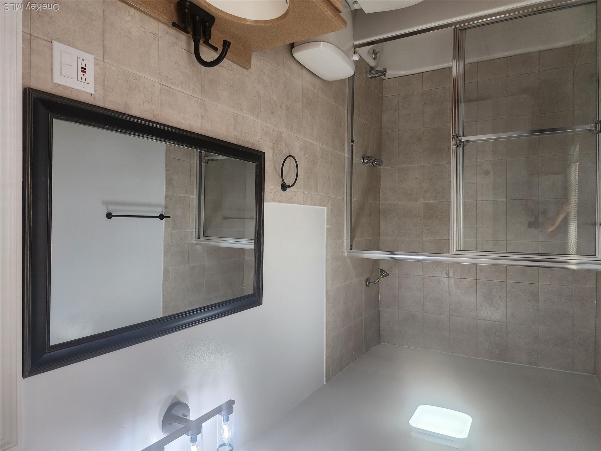 49 Carroll Street, Unit 1 Poughkeepsie, NY 12601 - Photo 10 of 15 a bathroom with a shower and a sink