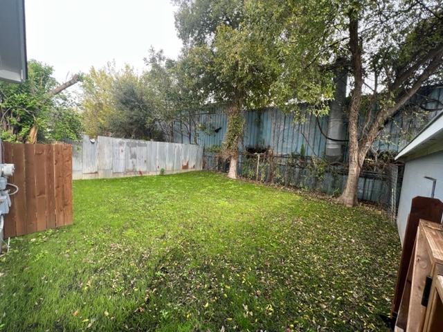 4417 Lucksinger Lane, Unit B Austin, TX 78745 - Photo 4 of 12 a view of a backyard with a small cabin and a chair
