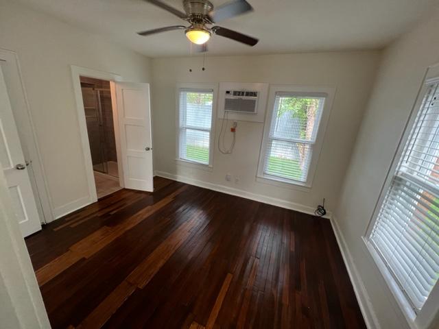 4417 Lucksinger Lane, Unit B Austin, TX 78745 - Photo 10 of 12 a view of an empty room with wooden floor and a window
