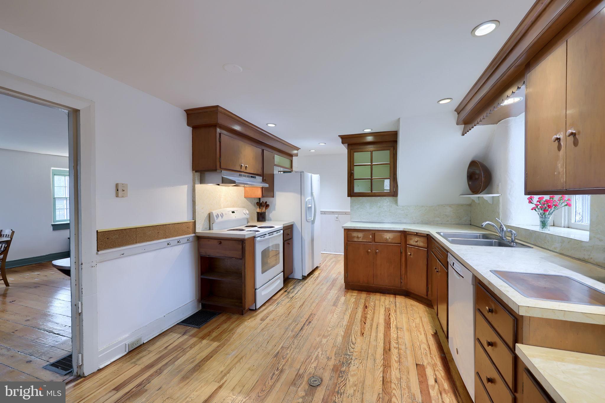 550 Speedwell Forge Road Lititz, PA 17543 - Photo 19 of 92 a kitchen with a sink dishwasher a stove and a refrigerator with wooden floor