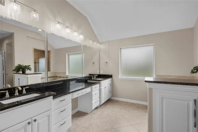 a kitchen with granite countertop a sink and cabinets