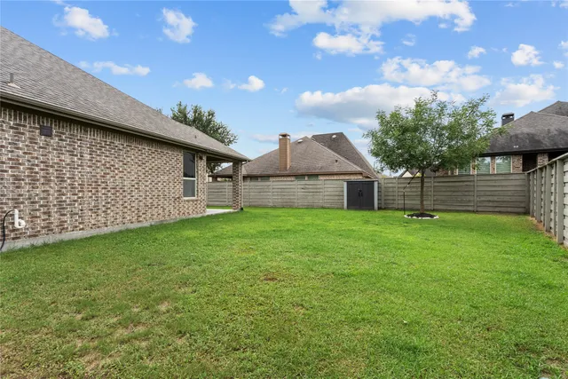 a backyard of a house with table and chairs