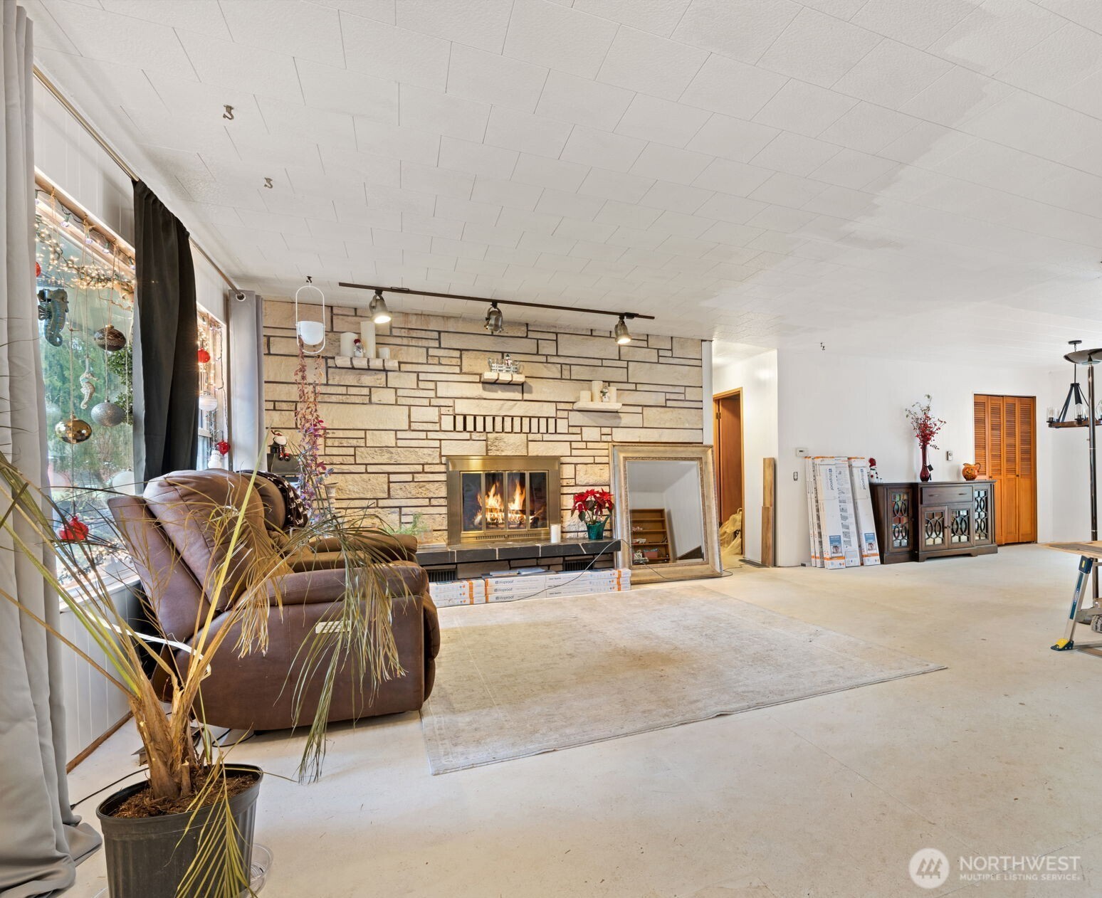 451 Elk Creek Road Chehalis, WA 98532 - Photo 5 of 31 a living room with furniture a flat screen tv and a large window