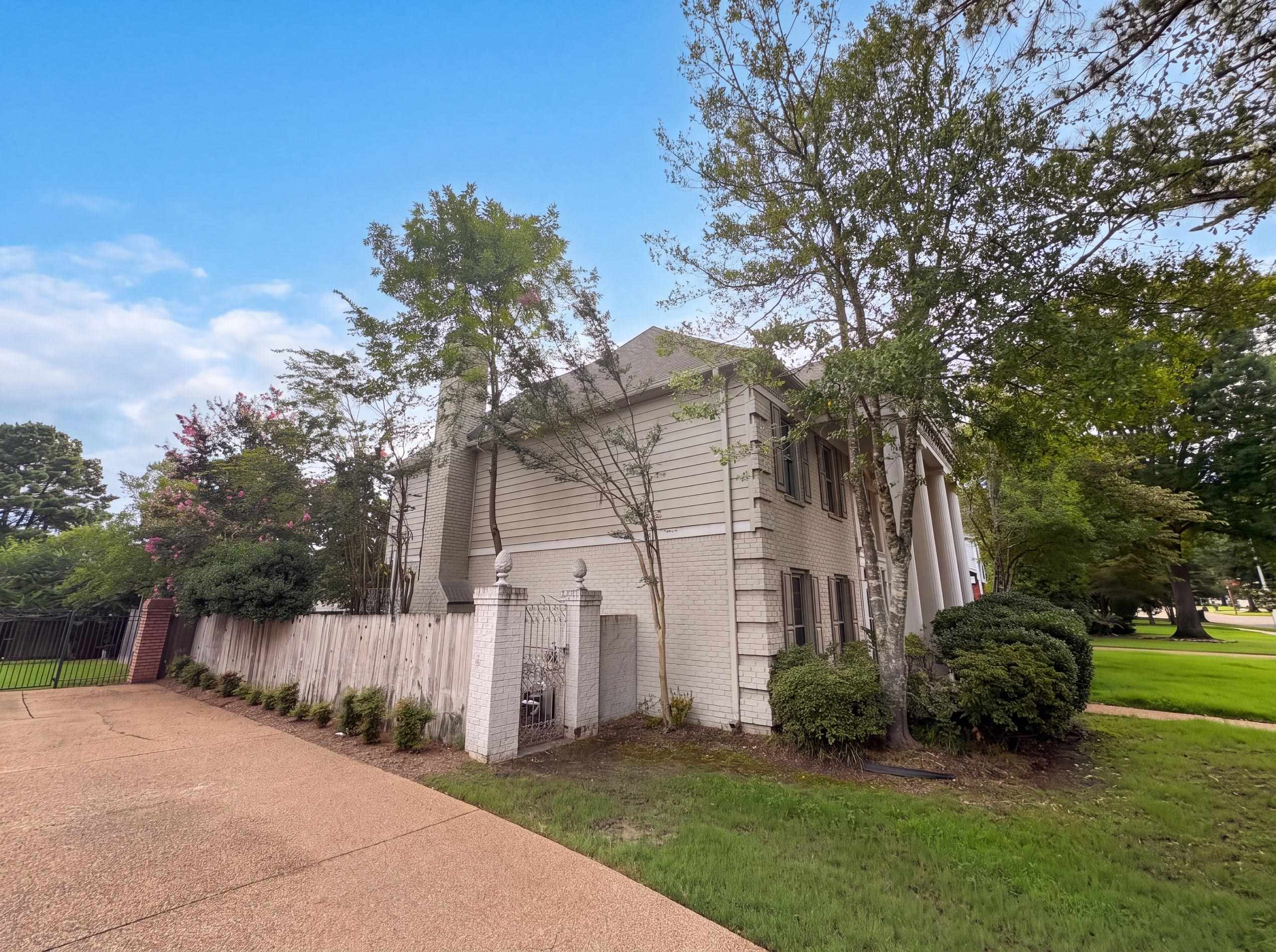 9424 Gotten Road Germantown, TN 38139 - Photo 27 of 27 Traditional style residence featuring a portico with four round columns, a brick and siding exterior, and shuttered windows