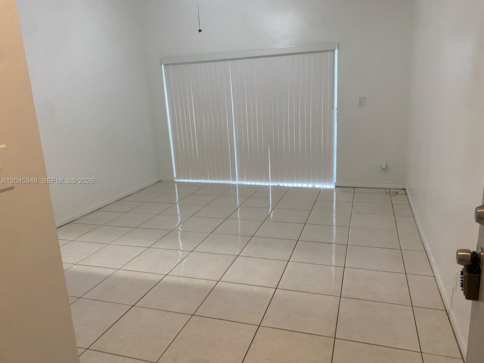 5612 Rock Island Road, Unit 167 Tamarac, FL 33319 - Photo 2 of 16 an empty room with a mirror