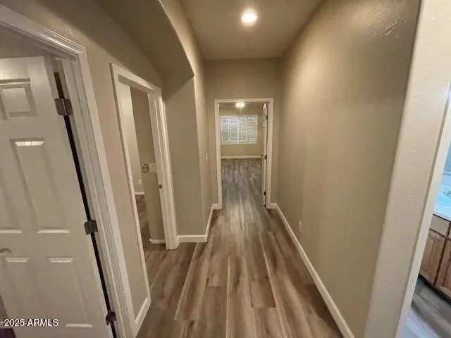 a view of hallway with wooden floor