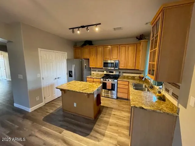 a kitchen with a stove a sink and a refrigerator