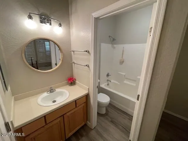 a bathroom with a sink mirror vanity and toilet