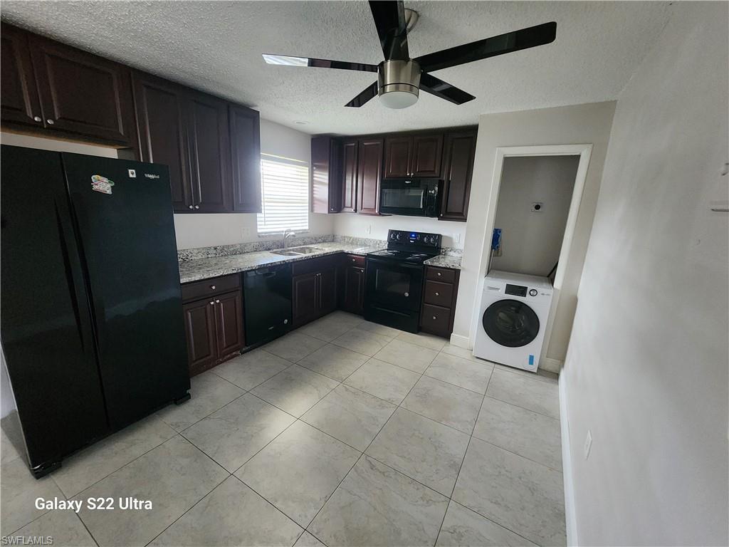 3325 Airport Road North, Unit N8 Naples, FL 34105 - Photo 7 of 22 a large kitchen with a stove and a refrigerator