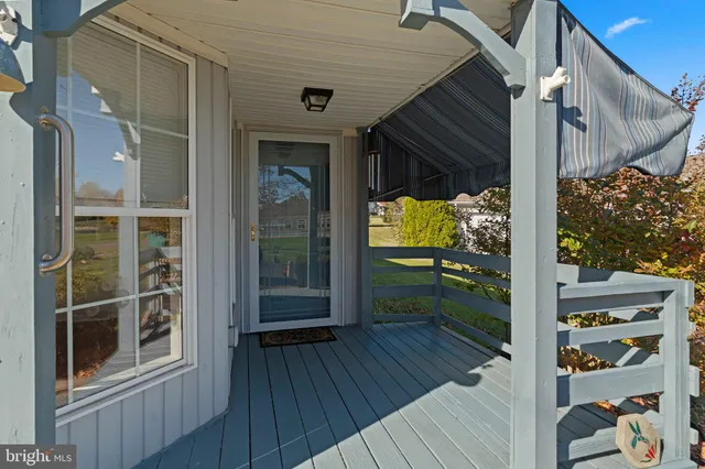 a view of a balcony with wooden floor and iron gate